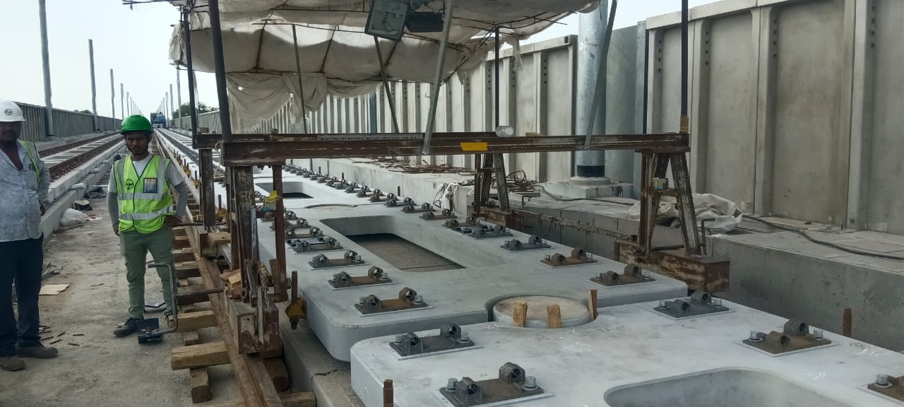 Precast slab track fastenings on viaduct with site engineers
